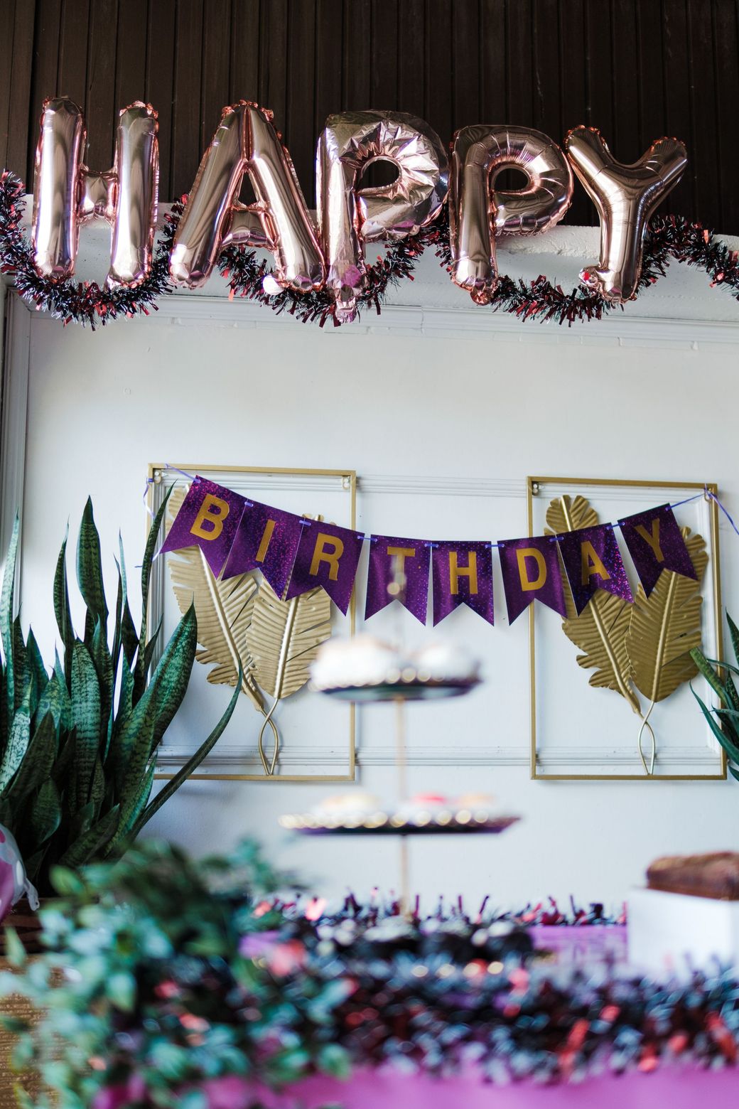 Happy Birthday balloon letters over a party table
