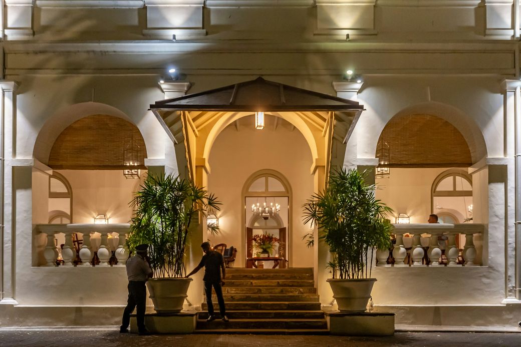 A lit, arched hotel entrance at night