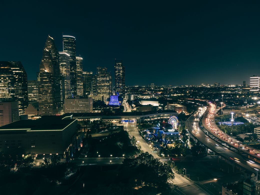 Downtown Houston at night with highway light trails